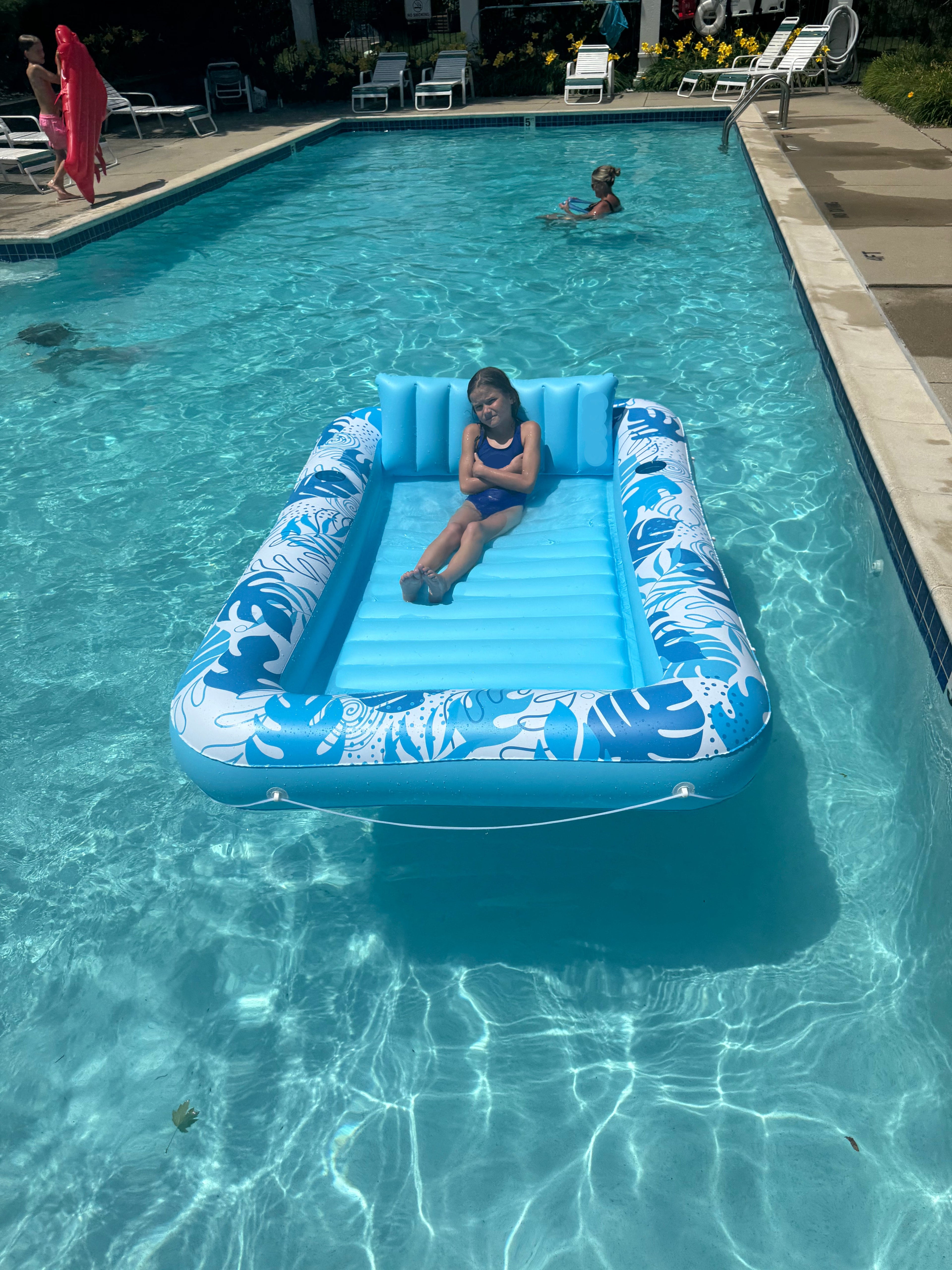 Person on an inflatable pool float in a swimming pool